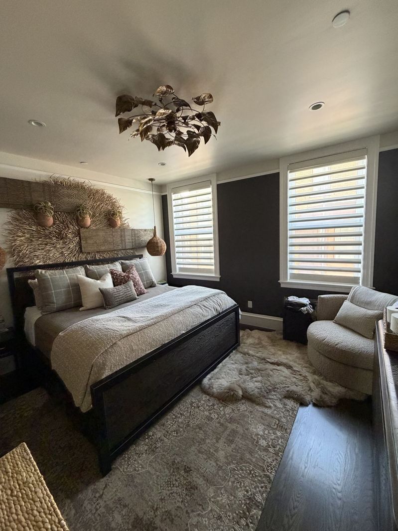 Primary bedroom with a dark painted accent wall