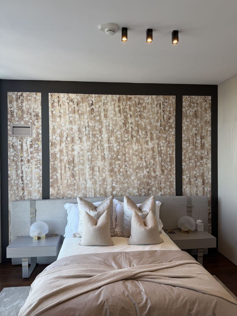 Bedroom with a decorative feature wall behind the headboard