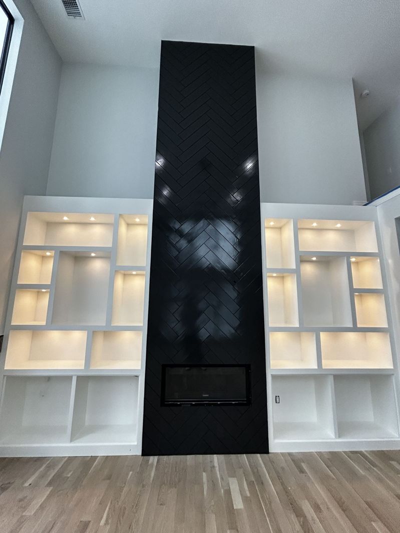 Herringbone fireplace wall after a high-gloss black finish (After)