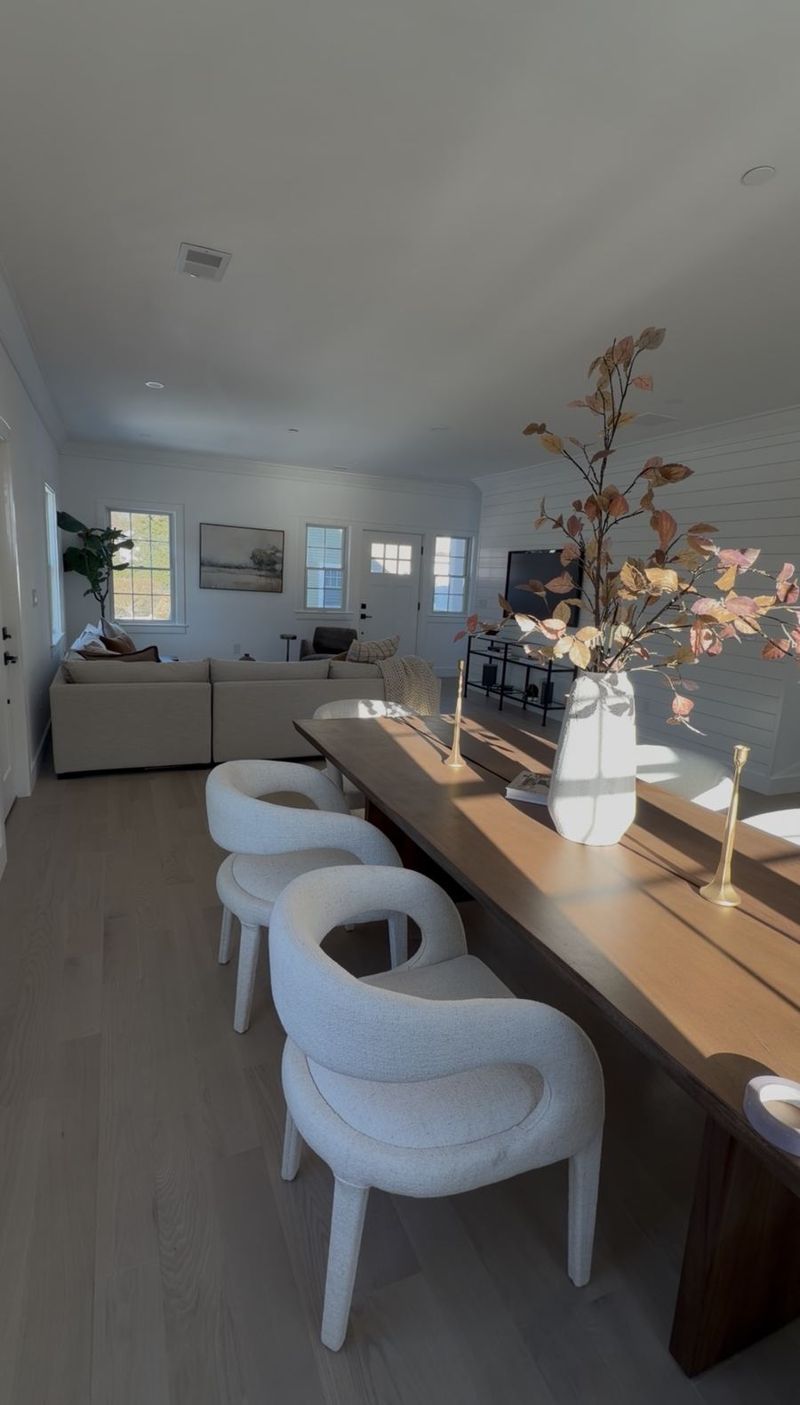 Living and dining room with painted white shiplap walls